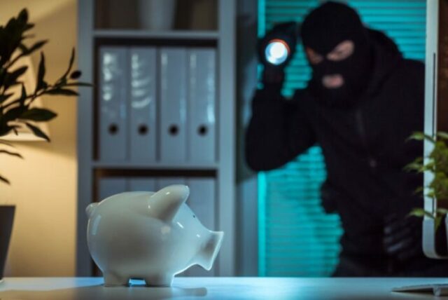 Robber stealing piggy bank